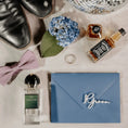 Load image into Gallery viewer, Groom Drink Topper n Blue envelope on Flatlay of Groomsmen essentials for wedding