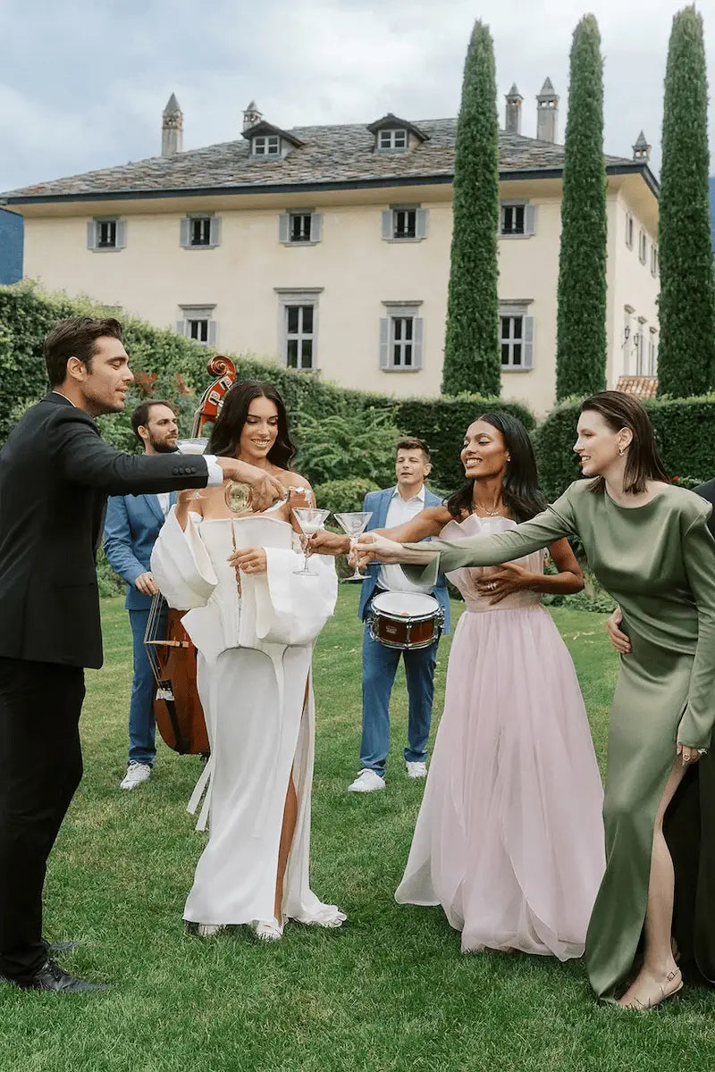 Bride and Groom at Wedding Dancing with guests and bridesmaids and drinking wine